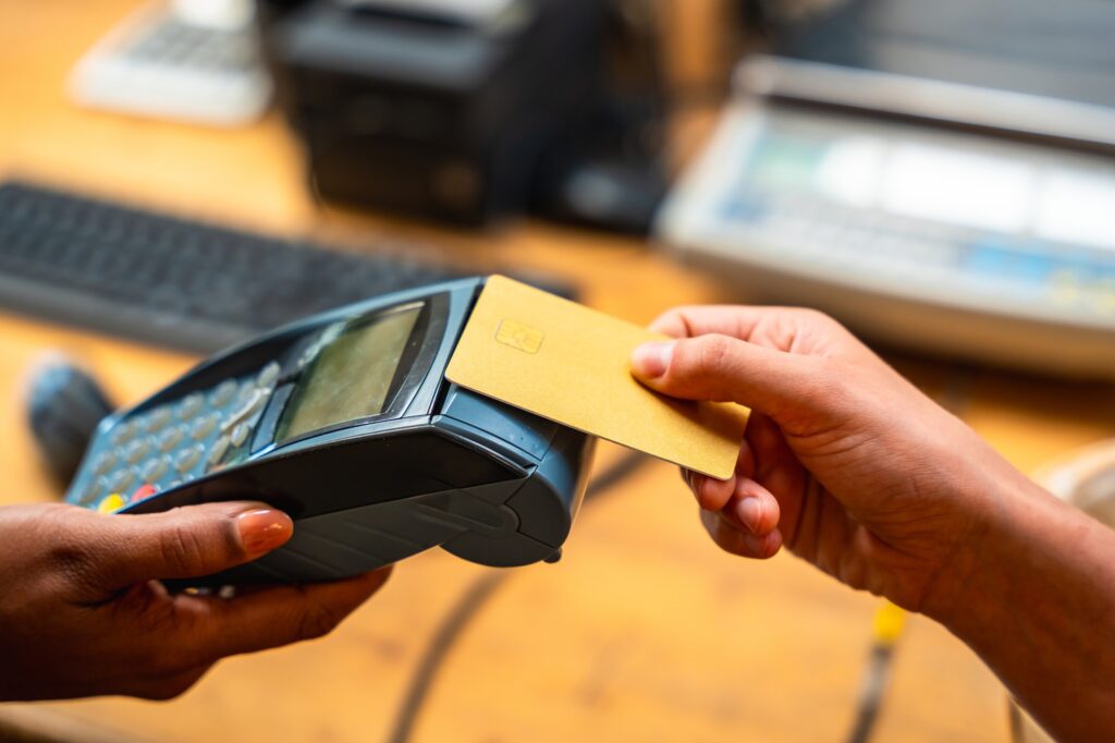 Customer paying with credit card on pos terminal in store